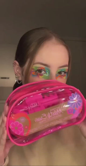 Video of woman grabbing hair with claw clip and removing her makeup with the Flowerbomb Set MakeUp Eraser cloth.