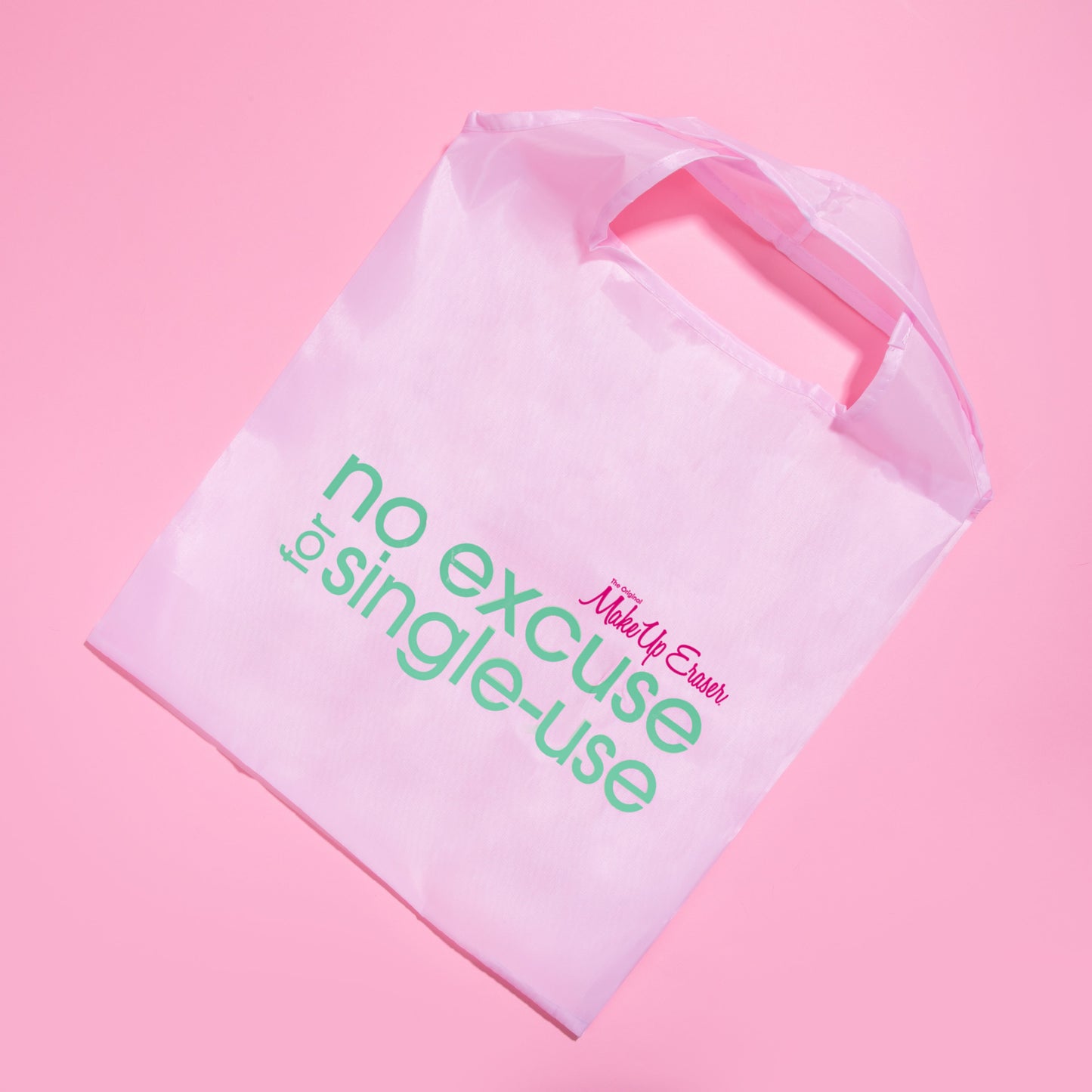 Pink reusable tote bag that reads "no excuse for single-use"