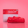 Love Red MakeUp Eraser packaging propped next to rolled cloth. 