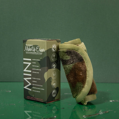 Rolled up Mini Camo MakeUp Eraser cloth next to packaging.