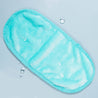 Fresh Turquoise MakeUp Eraser laying flat surrounded by waterdrops.