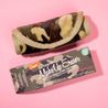 Rolled up Camo Print MakeUp Eraser next to packaging. 