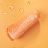 Rolled up Juicy Orange MakeUp Eraser surrounded by water.