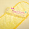 Mellow Yellow MakeUp Eraser packaging on top of Mellow Yellow MakeUp Eraser cloth.