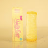 Rolled up Mellow Yellow cloth MakeUp Eraser next to packaging.