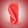 Rolled up Love Red MakeUp Eraser cloth with both sides exposed. The short fiber side is labeled as erase, and the long fiber side is labeled as exfoliate.