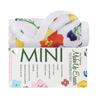 Rolled up Mini Wildflowers MakeUp Eraser cloth on top of packaging.