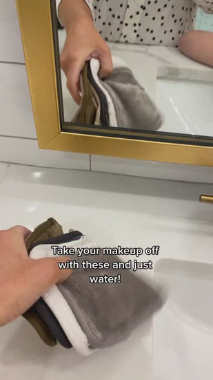Video of woman wetting MakeUp Eraser cloth and then removing her makeup with it.